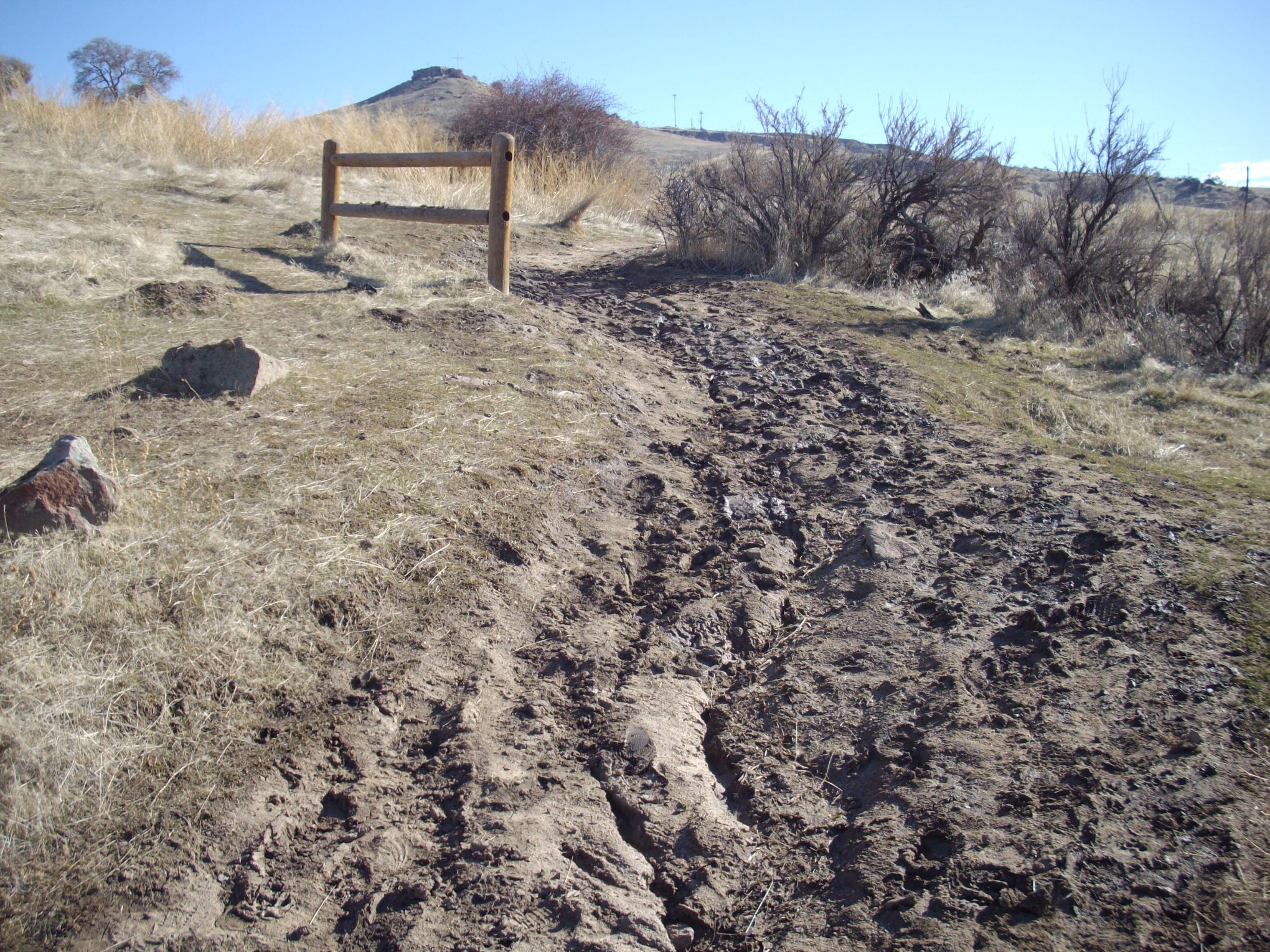 Muddy trail shows obvious signs of damage from use.